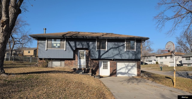 bi-level home with a front yard and a garage