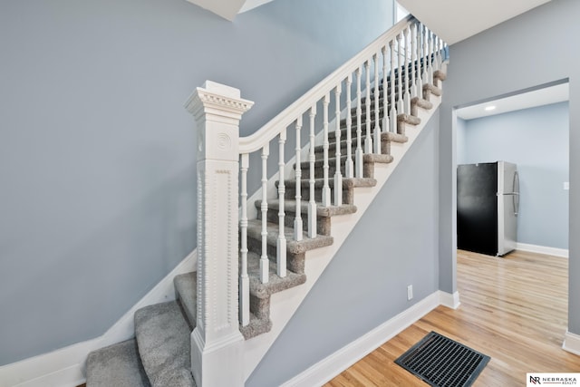 stairway featuring hardwood / wood-style floors