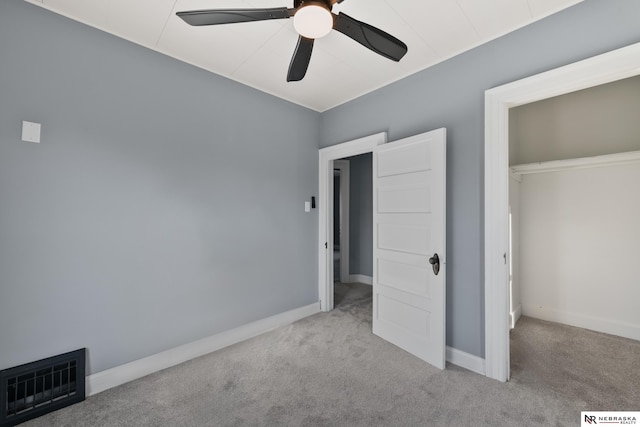 unfurnished bedroom featuring ceiling fan, a closet, and light carpet