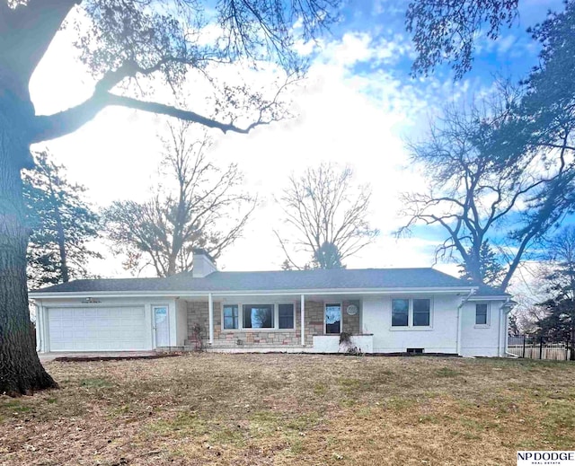 ranch-style home with a front lawn and a garage