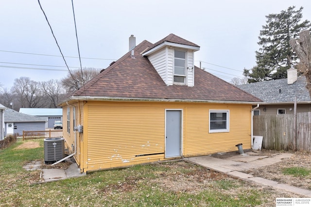 rear view of property with central AC unit and a patio area