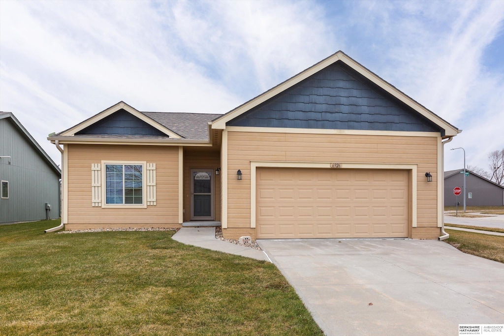 view of front of property with a front lawn and a garage