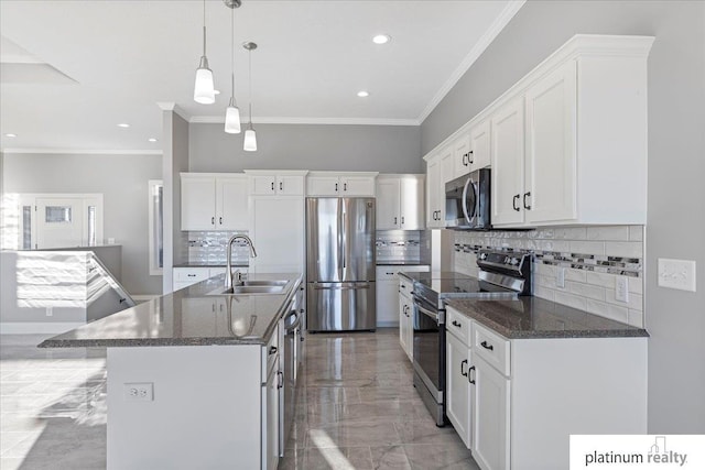 kitchen featuring white cabinets, a kitchen island with sink, sink, and appliances with stainless steel finishes