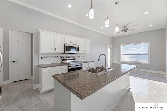 kitchen with white cabinets, sink, a kitchen island with sink, and appliances with stainless steel finishes