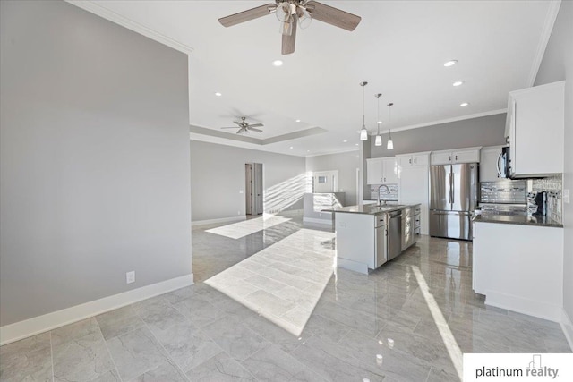 kitchen featuring sink, an island with sink, decorative light fixtures, white cabinetry, and stainless steel appliances