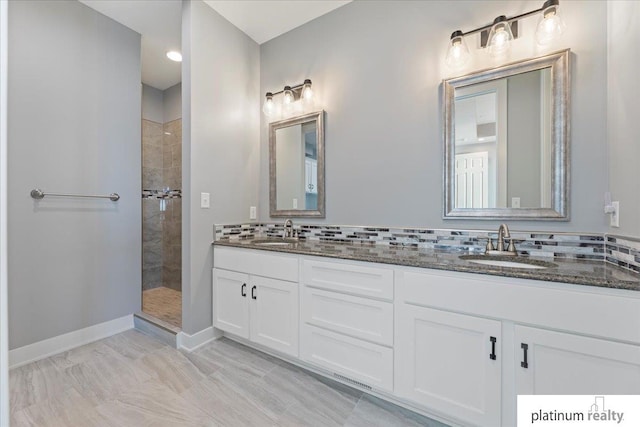 bathroom featuring decorative backsplash, vanity, and tiled shower