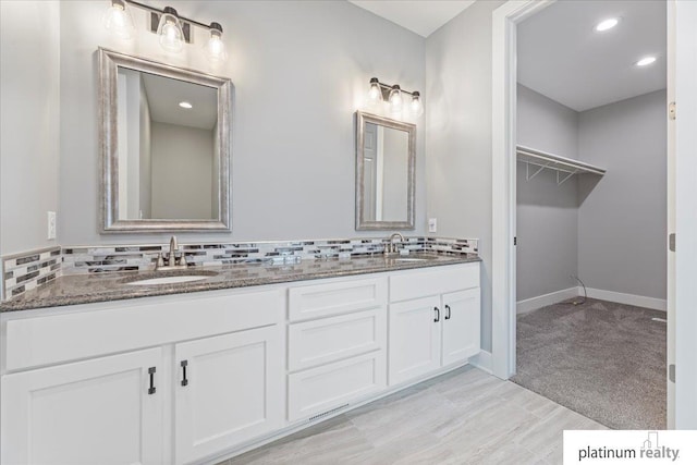 bathroom featuring decorative backsplash and vanity