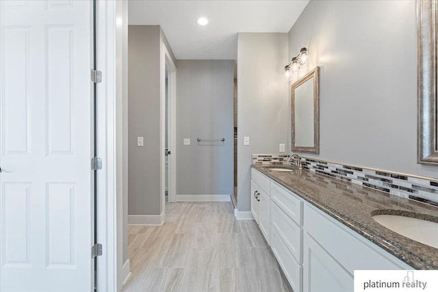 bathroom with vanity and tasteful backsplash