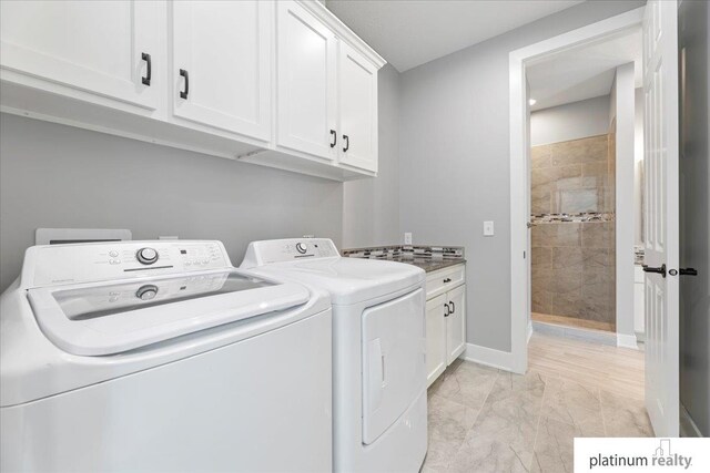 laundry room featuring cabinets and independent washer and dryer