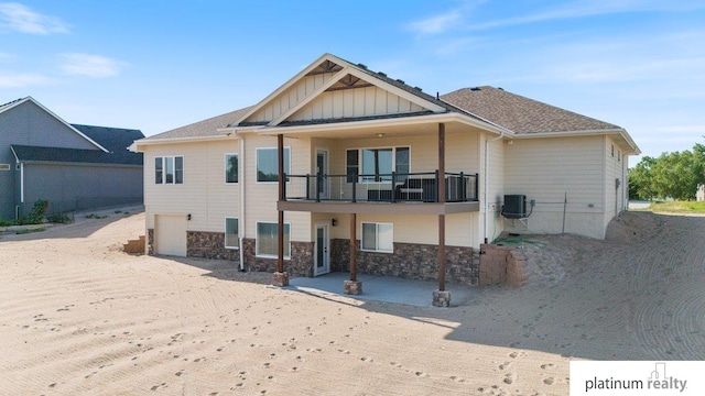 rear view of property with central AC, a balcony, and a patio