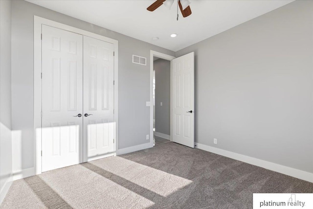 unfurnished bedroom featuring carpet flooring, a closet, and ceiling fan