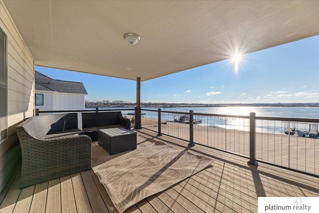 deck featuring a beach view, outdoor lounge area, and a water view