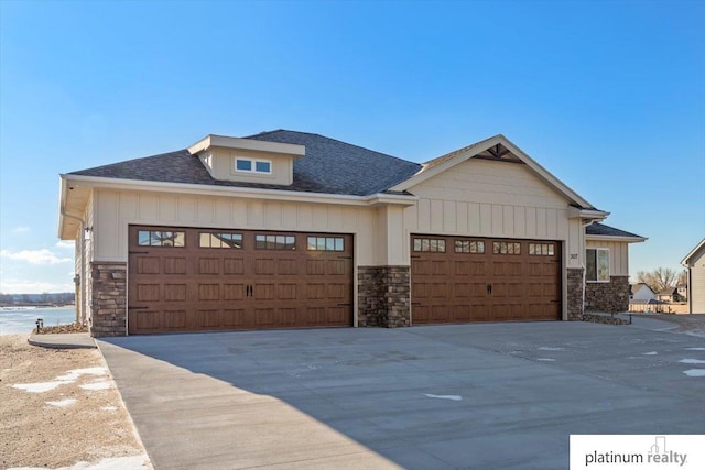 view of front of home with a water view and a garage