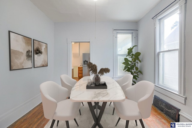 dining space with hardwood / wood-style flooring and plenty of natural light