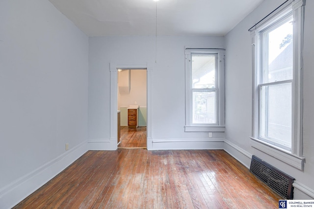 empty room featuring wood-type flooring