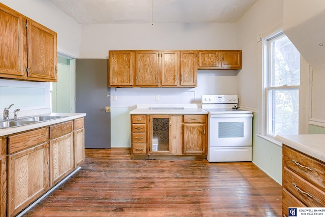 kitchen featuring white range with electric cooktop, sink, and dark wood-type flooring