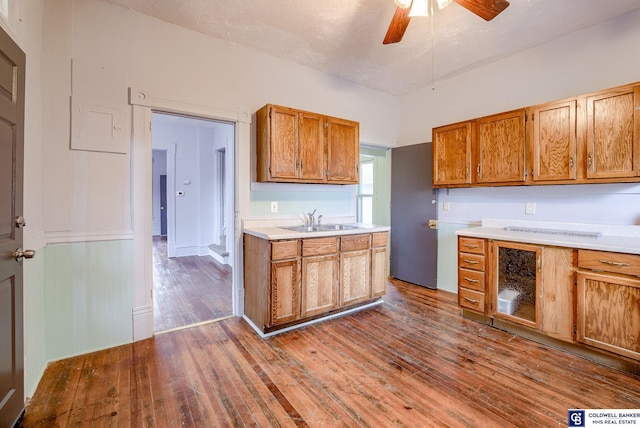 kitchen with dark hardwood / wood-style floors, ceiling fan, and sink