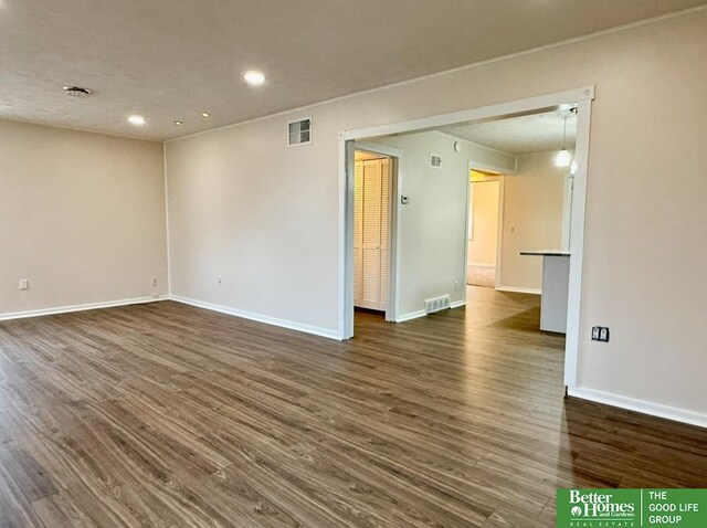 empty room featuring dark hardwood / wood-style flooring