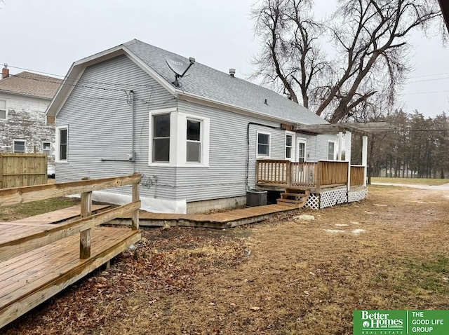 back of property featuring a wooden deck and cooling unit