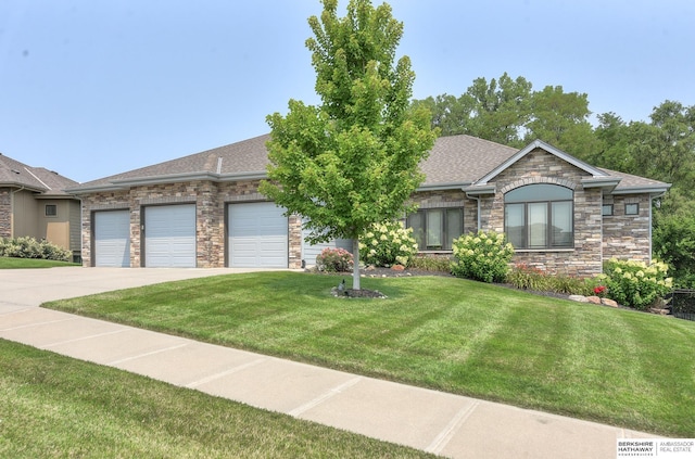 view of front of house with a front yard and a garage