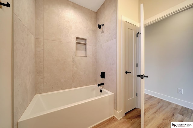 bathroom with wood-type flooring and tiled shower / bath combo