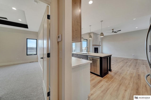 kitchen featuring pendant lighting, a center island, sink, stainless steel dishwasher, and ceiling fan