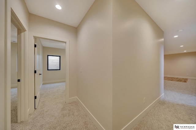 hallway with light colored carpet