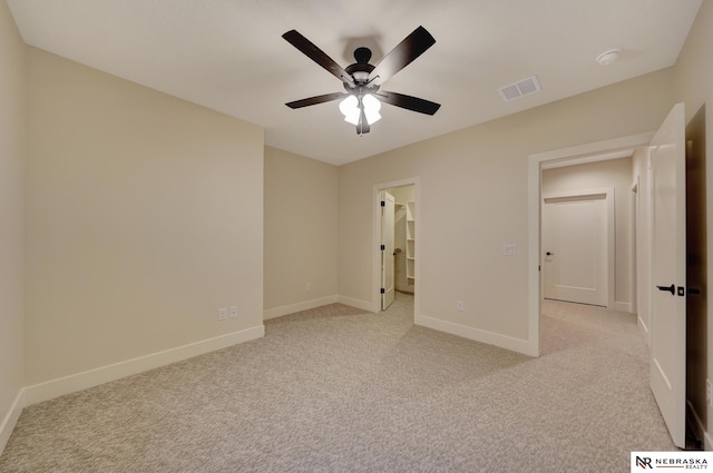 unfurnished bedroom featuring ceiling fan and light carpet