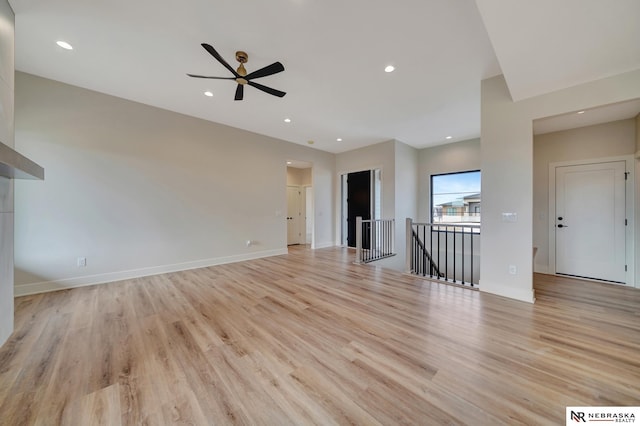 unfurnished living room with light hardwood / wood-style flooring and ceiling fan