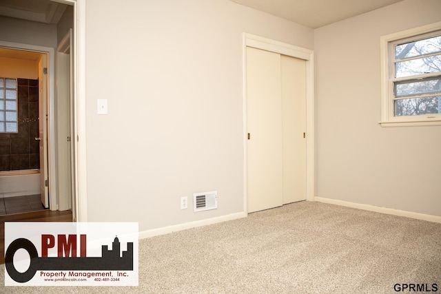 unfurnished bedroom featuring carpet floors and a closet