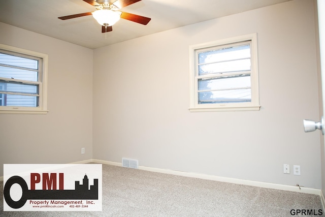 carpeted spare room featuring ceiling fan