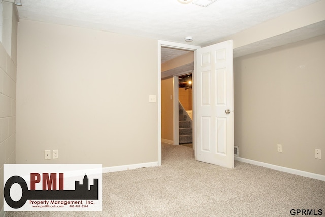 unfurnished room with light carpet