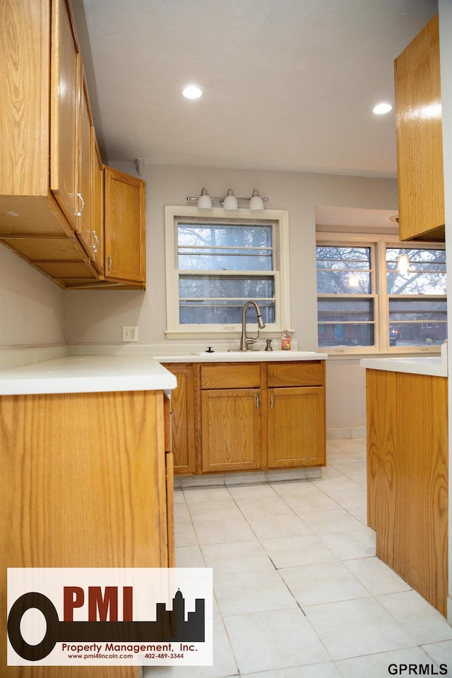 kitchen featuring light tile patterned flooring and sink