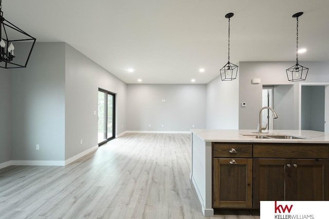 1450 Montana St, Superior, NE 68978 - kitchen featuring a sink, light wood finished floors, open floor plan, light countertops, and recessed lighting