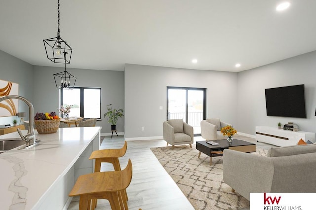 1450 Montana St, Superior, NE 68978 - living room featuring recessed lighting, light wood-style floors, healthy amount of natural light, a chandelier, and baseboards
