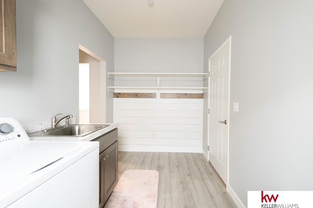 1450 Montana St, Superior, NE 68978 - laundry area featuring washer / dryer, cabinet space, and light wood-style floors