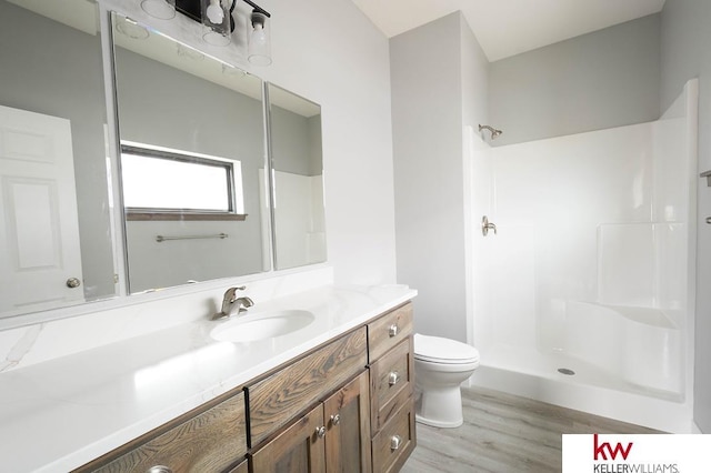 1450 Montana St, Superior, NE 68978 - bathroom featuring wood finished floors, a shower, toilet, and vanity