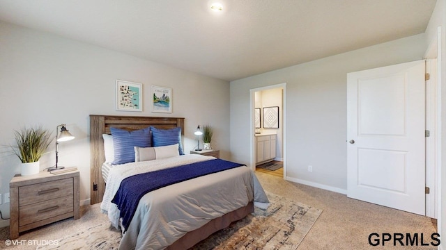 bedroom with connected bathroom and light colored carpet