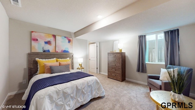 carpeted bedroom featuring a textured ceiling