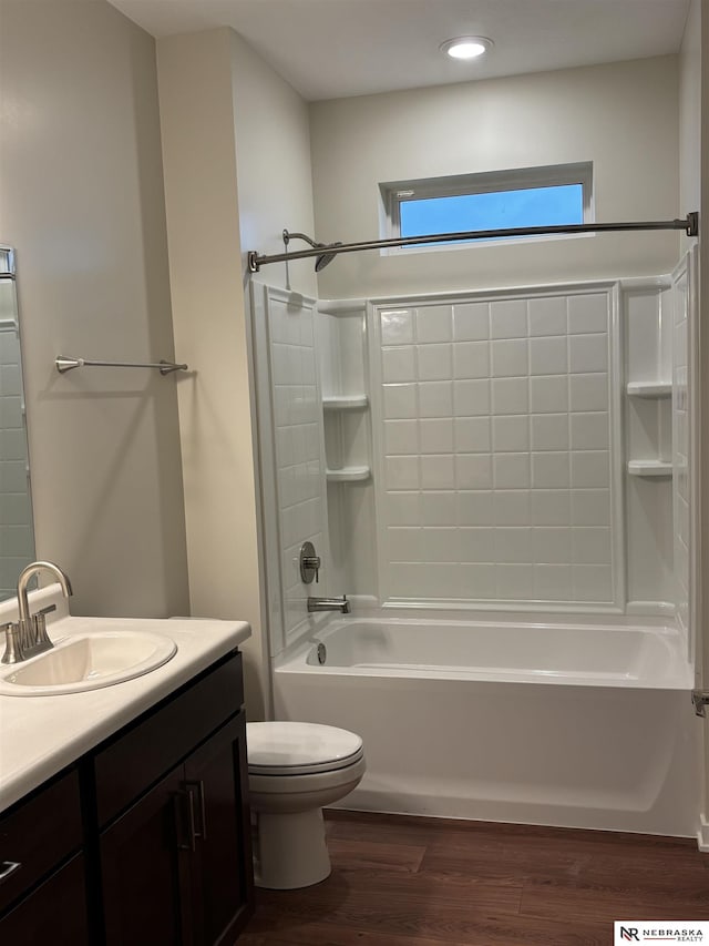 full bathroom featuring hardwood / wood-style flooring, vanity, toilet, and shower / tub combination