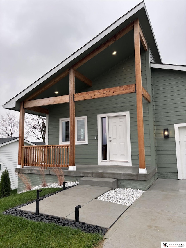 rear view of property featuring a porch