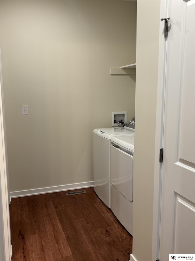 laundry area featuring independent washer and dryer and dark wood-type flooring