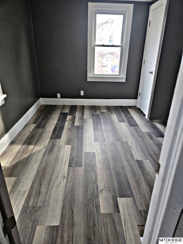 empty room featuring dark wood-type flooring