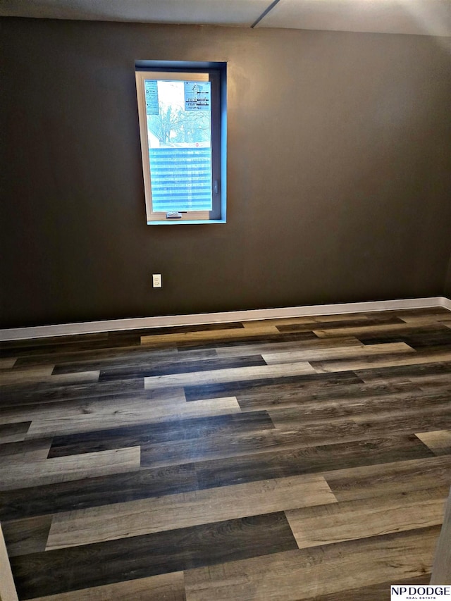 spare room with dark hardwood / wood-style floors