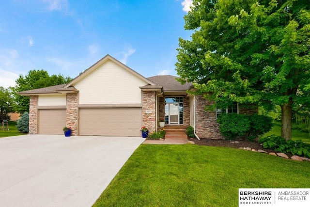 view of front of property featuring a garage and a front yard