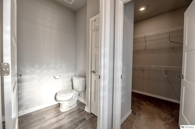 bathroom with toilet and hardwood / wood-style flooring