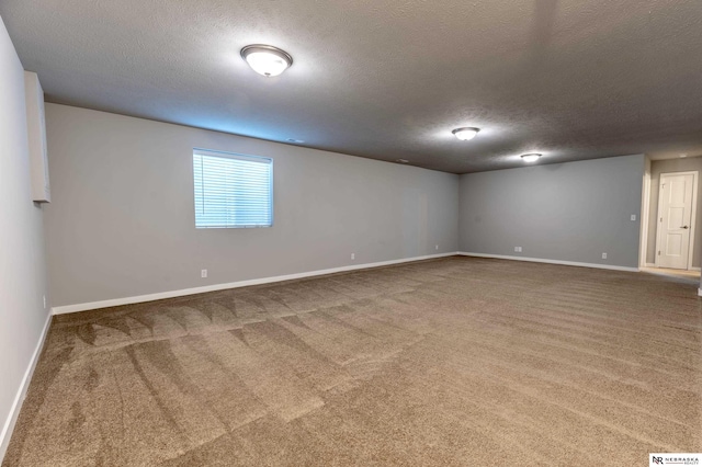 empty room with a textured ceiling and carpet floors