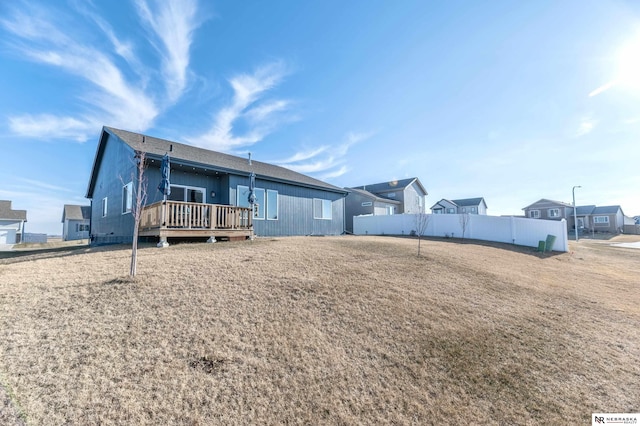 rear view of house featuring a wooden deck