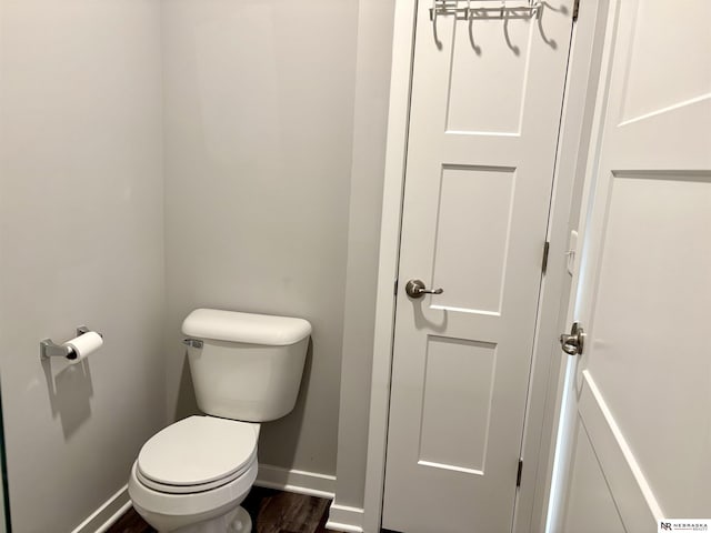 bathroom featuring toilet and wood-type flooring