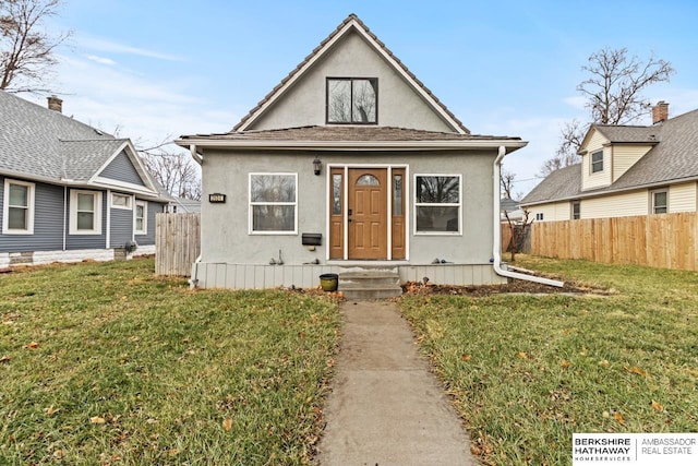 bungalow-style home with a front lawn